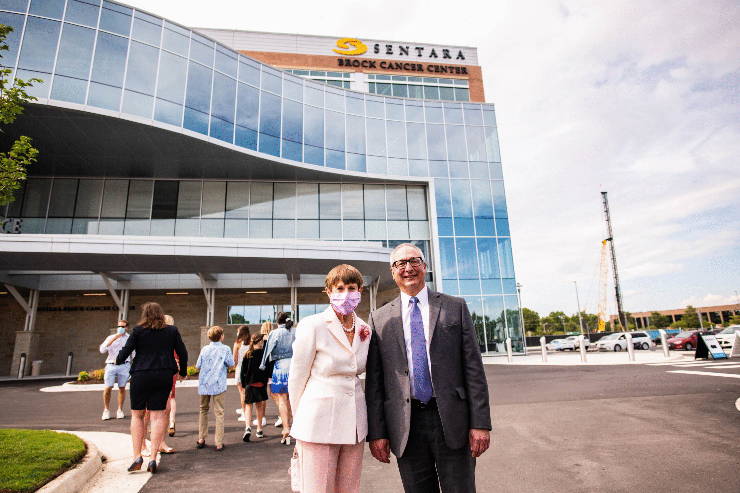 Joan Brock and Dr. Thomas Alberico stand in front of the newly built Sentara Brock Cancer Center in 2020. 