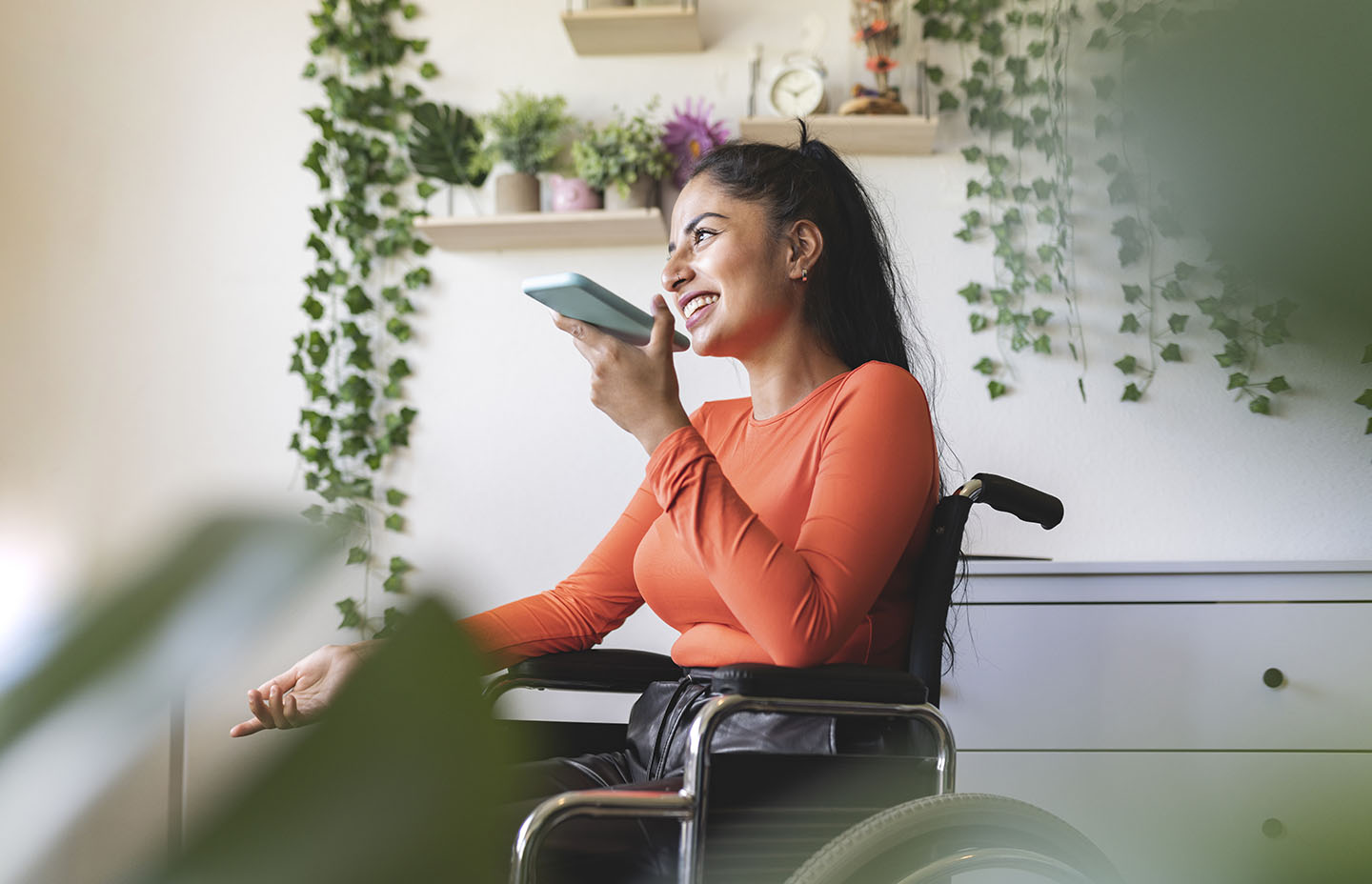 Smiling disabled woman talking on mobile phone at home